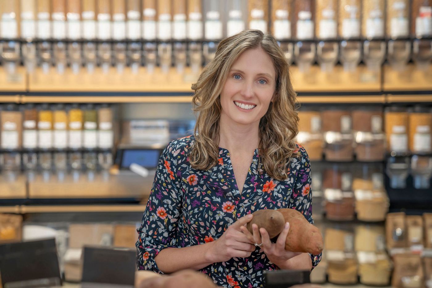 Dr. Kathryn Hall smiling while shopping for fresh produce
